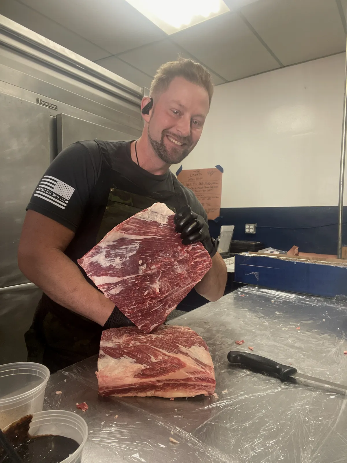 Chef Bryan Jacobs trimming a raw brisket